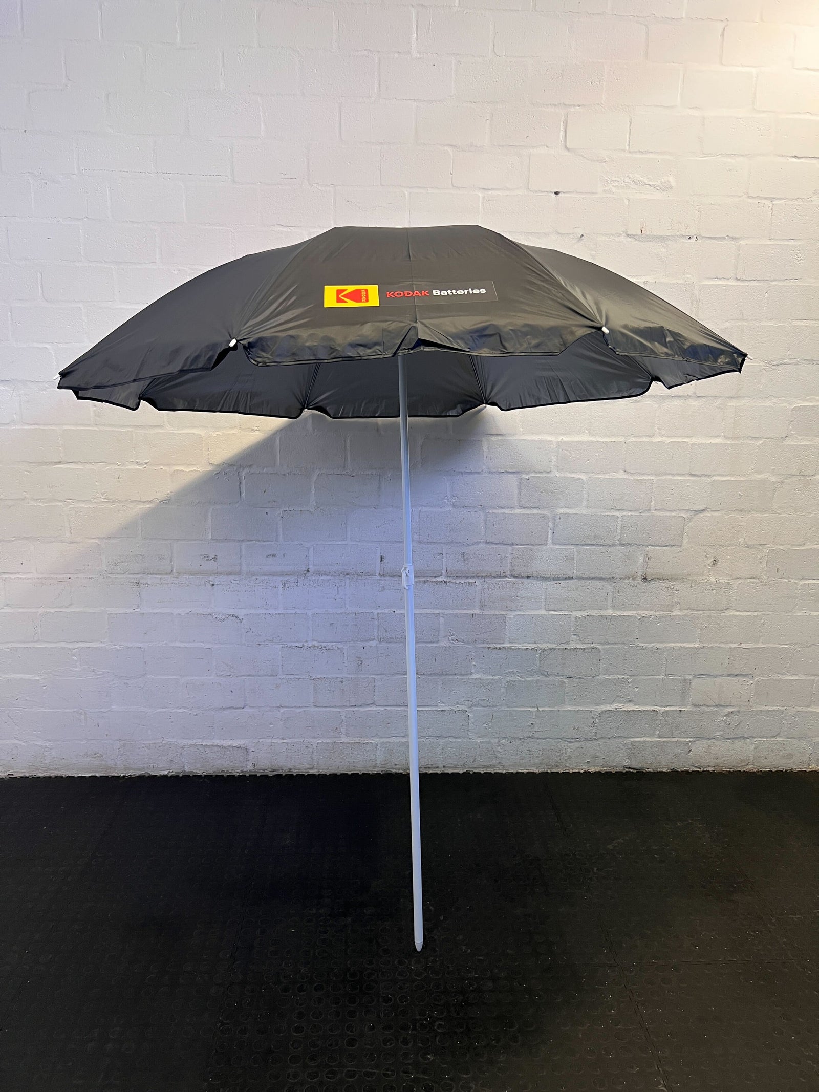 Stylish Black Kodak Batteries Beach Umbrella – Slight Wear