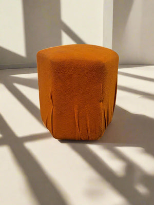 Orange textured stool on a light background
