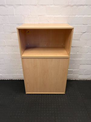 Wooden cabinet against a white brick wall