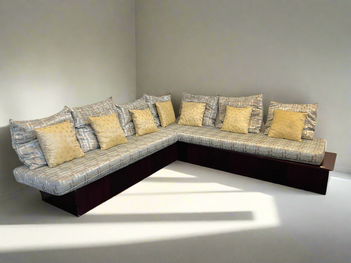 Sectional sofa with patterned cushions on a plain background