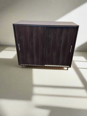 Dark wooden cabinet with two doors on a light background