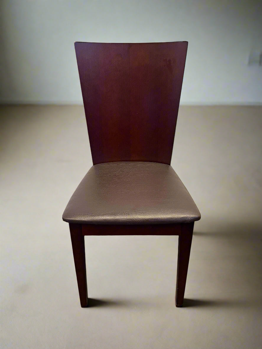 Brown chair on a beige floor with a plain white wall background