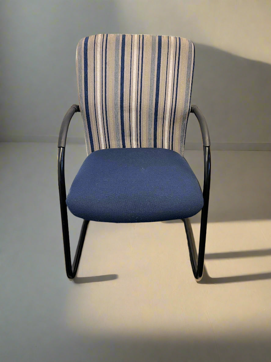 Chair with striped backrest and blue seat on a plain background