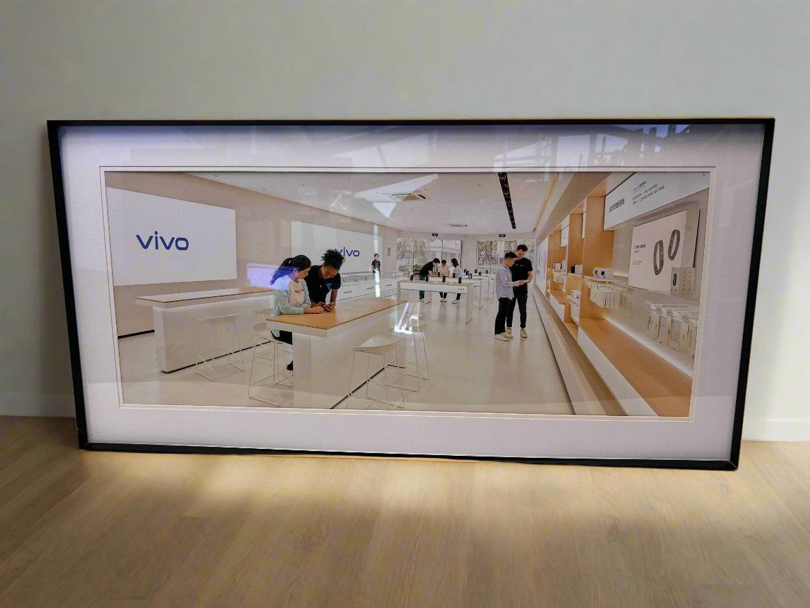Framed picture of a modern office space with 'vivo' branding.
