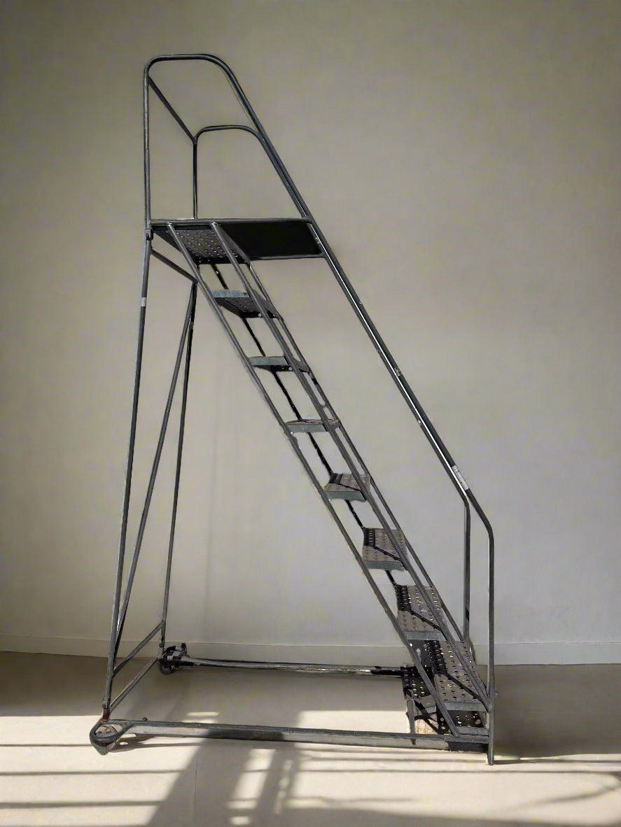Metal rolling ladder on a plain background