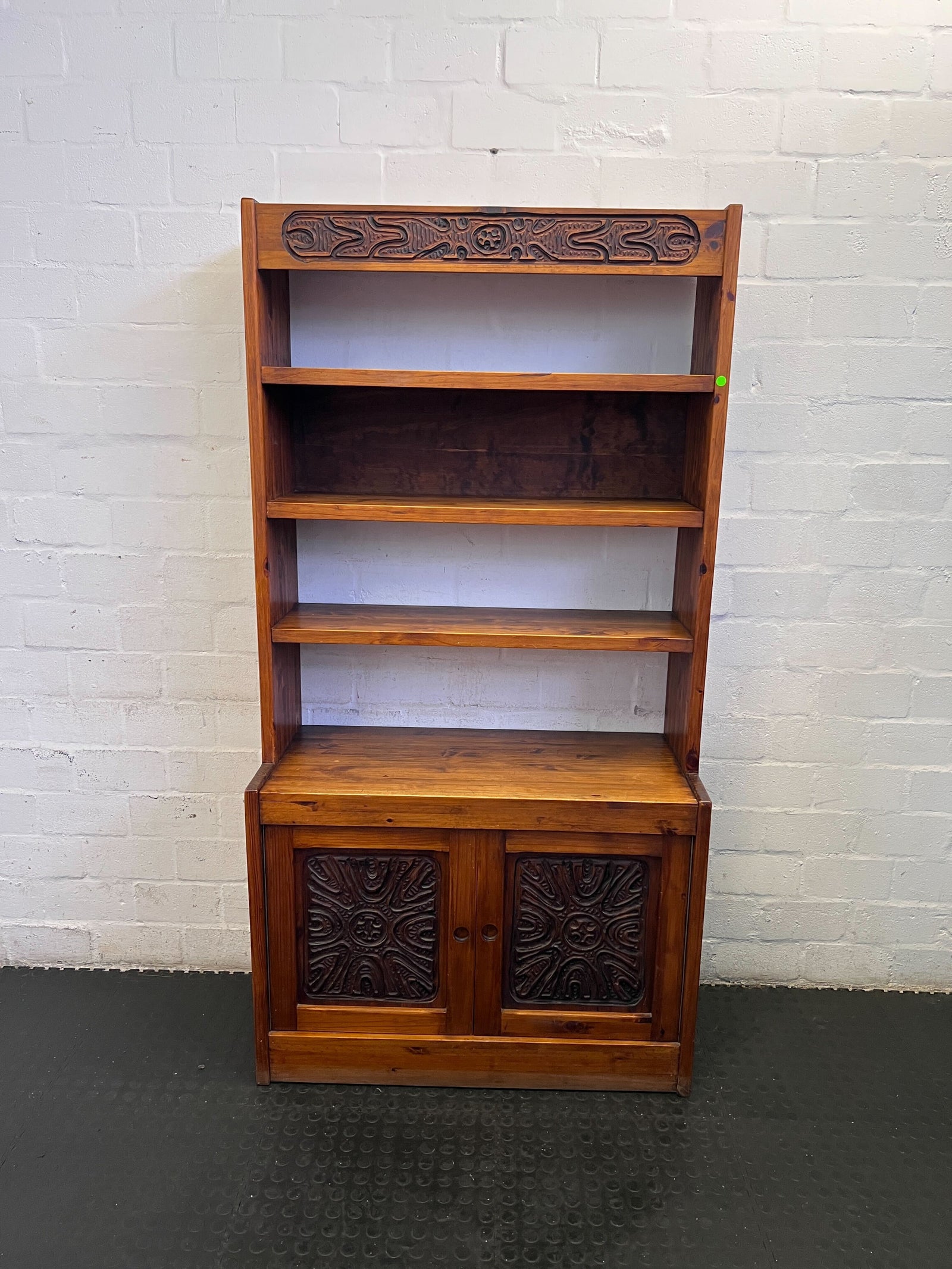 Rustic Wooden Bookshelf with Carved Detail, Slightly Worn