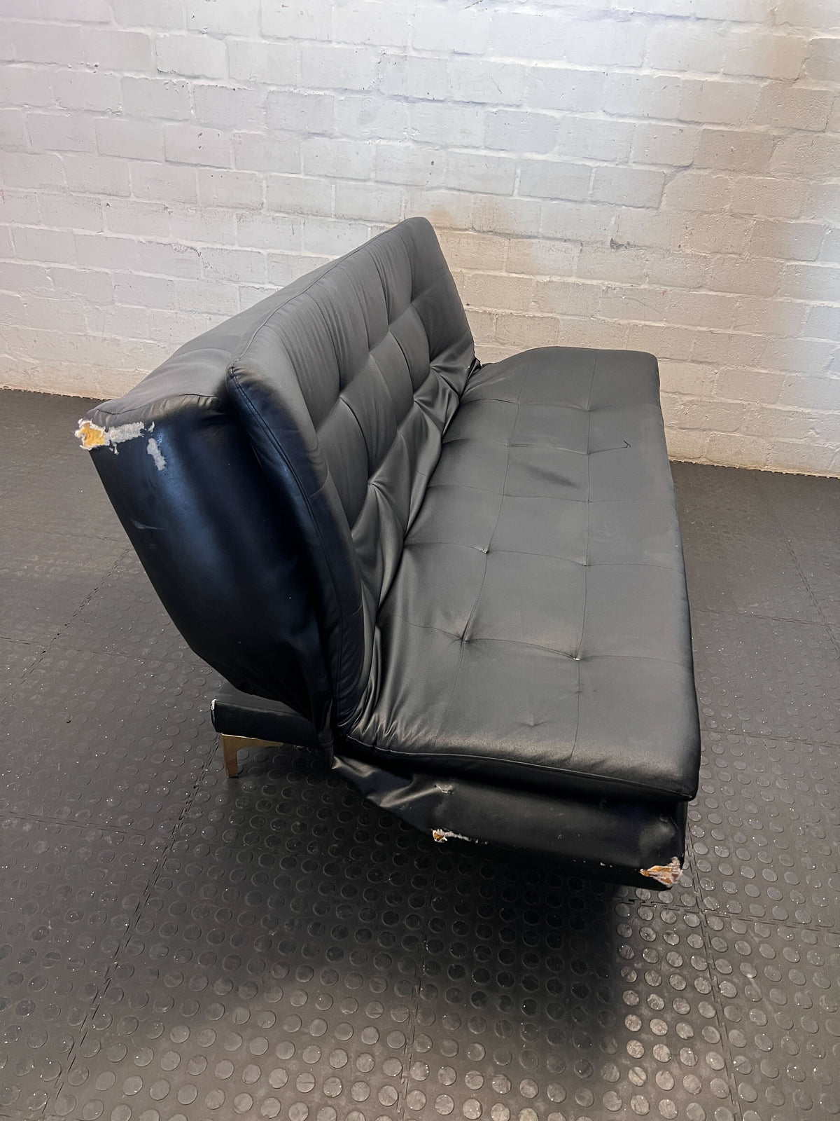 Versatile Black Faux Leather Futon Sofa Bed with Gold Accents - Broken one side - 2ndhandwarehouse.com