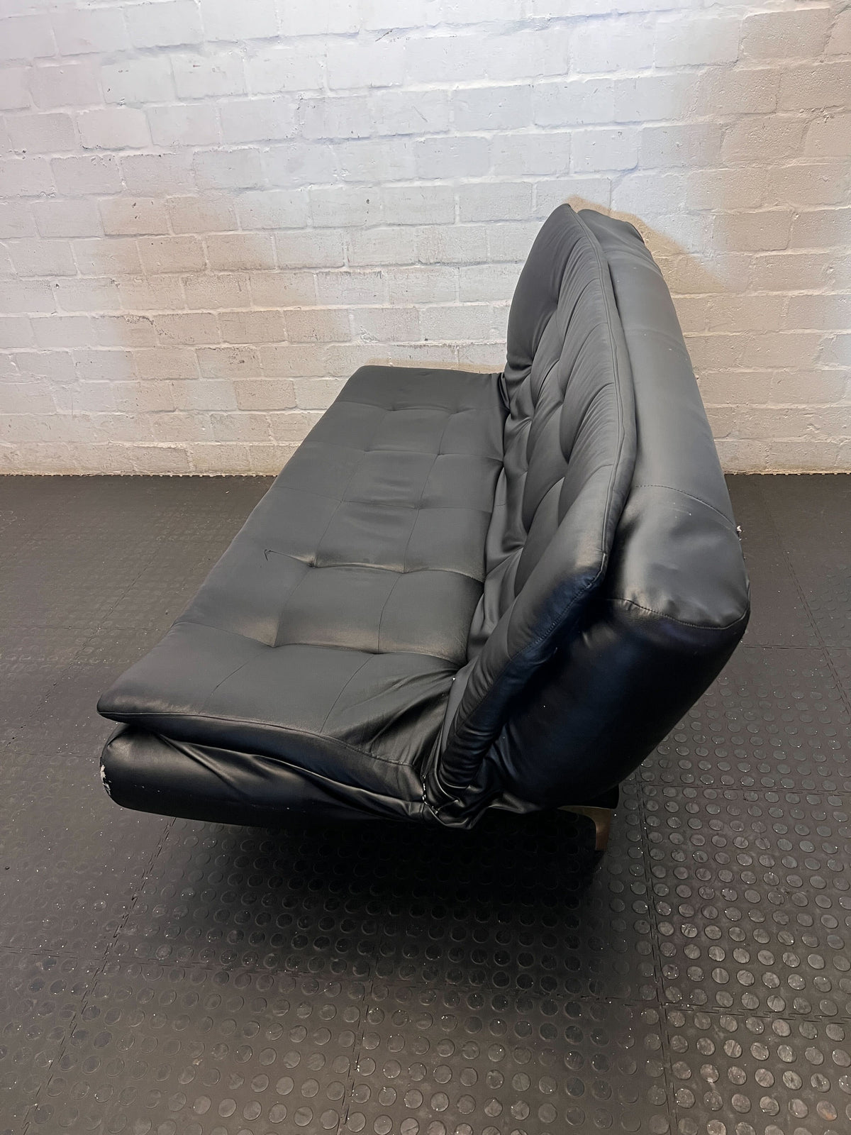 Versatile Black Faux Leather Futon Sofa Bed with Gold Accents - Broken one side - 2ndhandwarehouse.com