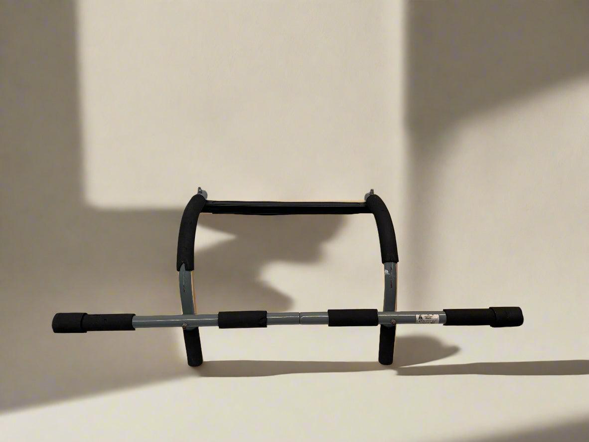 Black and gray pull-up bar on a beige background