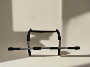 Black and gray pull-up bar on a beige background