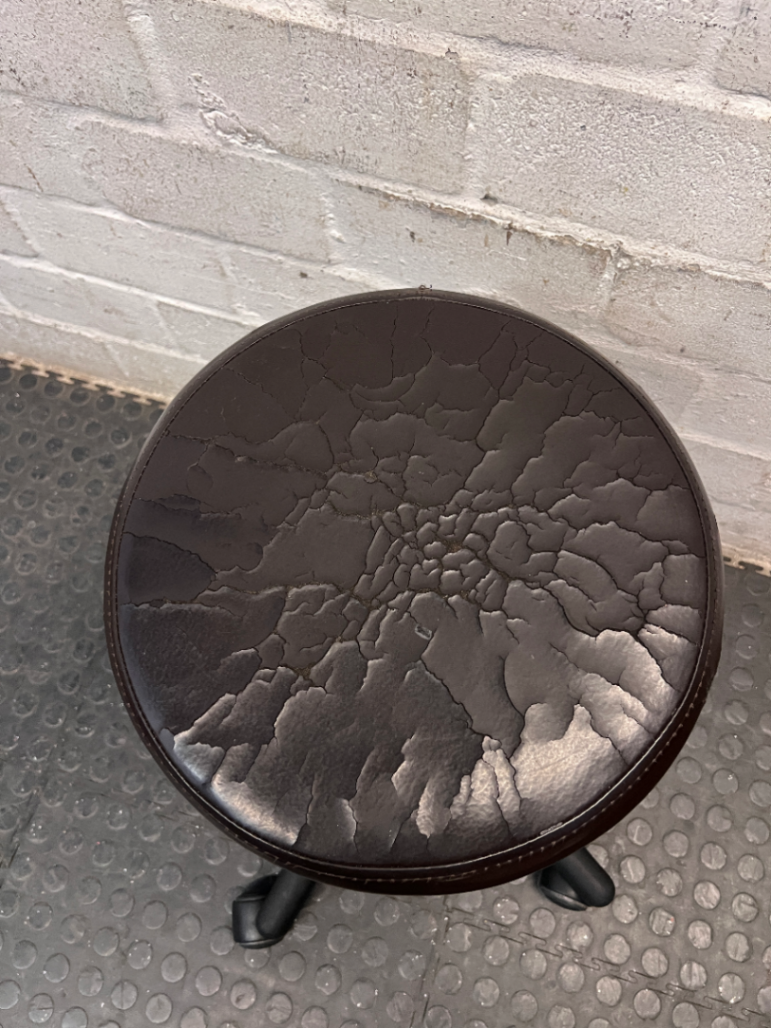 Adjustable Swivel Stool with Castors in Brown — Cracked and Peeling Seat Surface