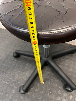 Adjustable Swivel Stool with Castors in Brown — Cracked and Peeling Seat Surface