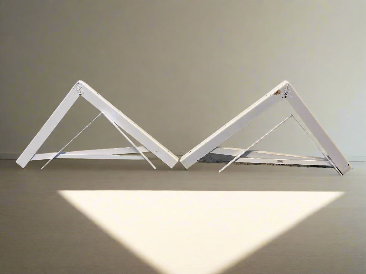 White metal folding table on a plain background