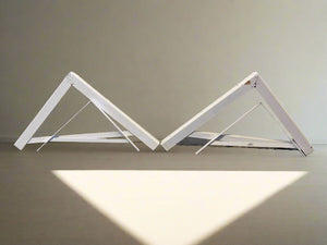 White metal folding table on a plain background