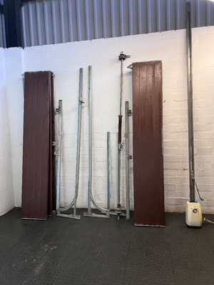Brown Metal Sectional Garage Door with Motor and Tracks — One Door With Snapped Tensioner; Both Motors Working