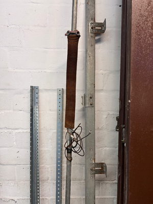Brown Metal Sectional Garage Door with Motor and Tracks — One Door With Snapped Tensioner; Both Motors Working