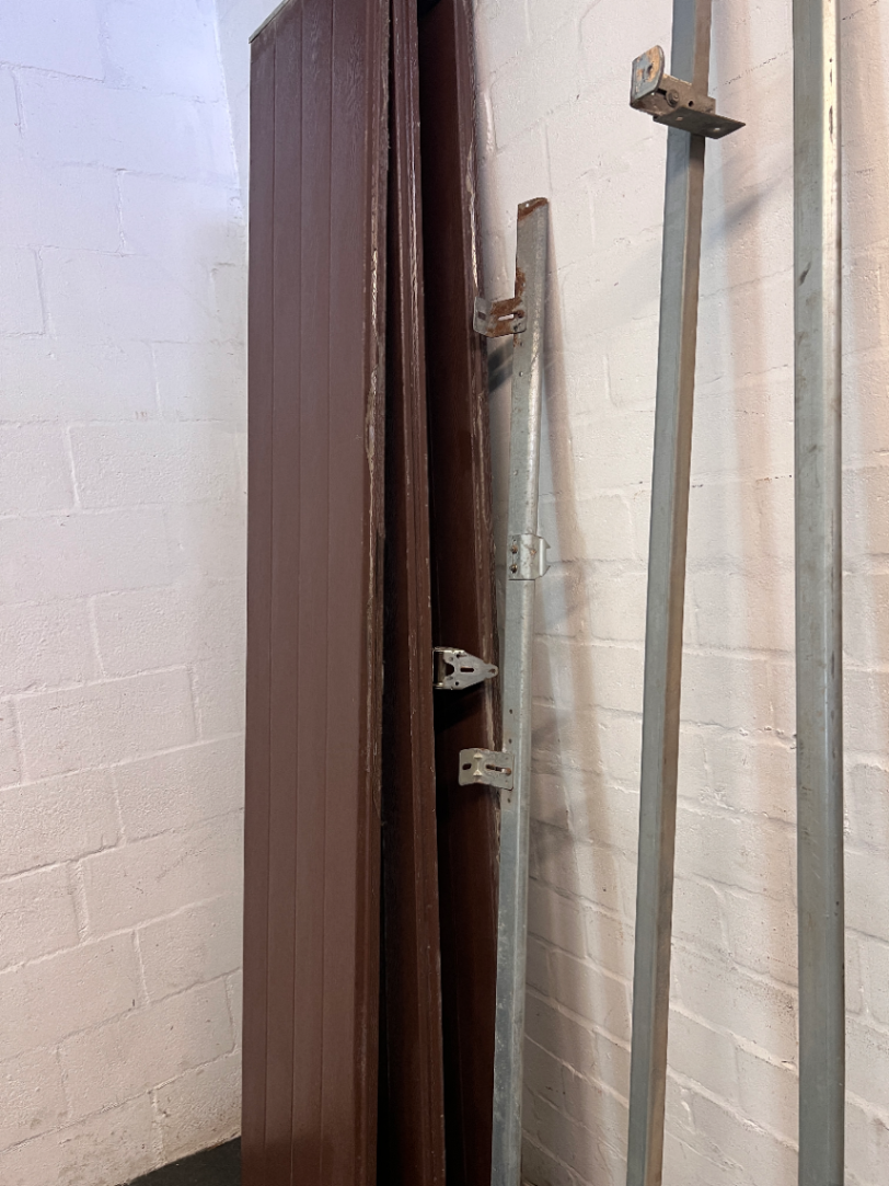 Brown Metal Sectional Garage Door with Motor and Tracks — One Door With Snapped Tensioner; Both Motors Working