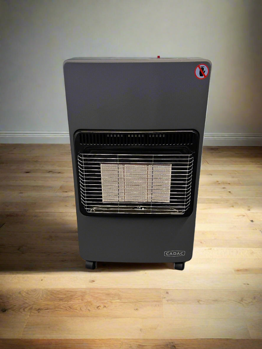 Portable gas heater on a wooden floor with a plain wall background