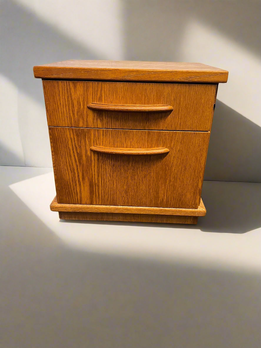 Wooden two-drawer nightstand on a plain background