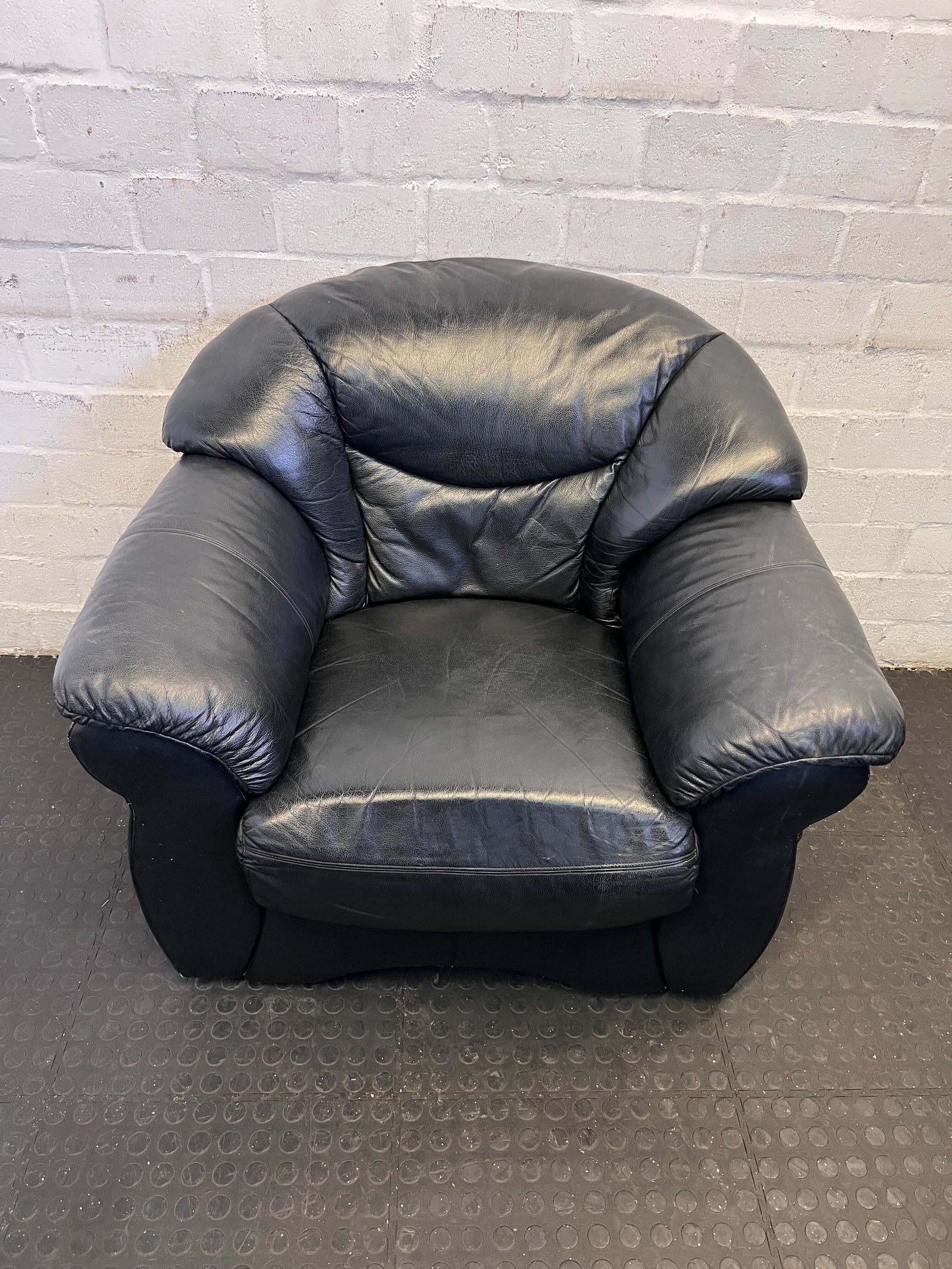 Comfortable Black Leather Armchair with Minor Wear