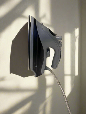 Compact Grey Steam Iron with Minor Wear – Not in Working Condition