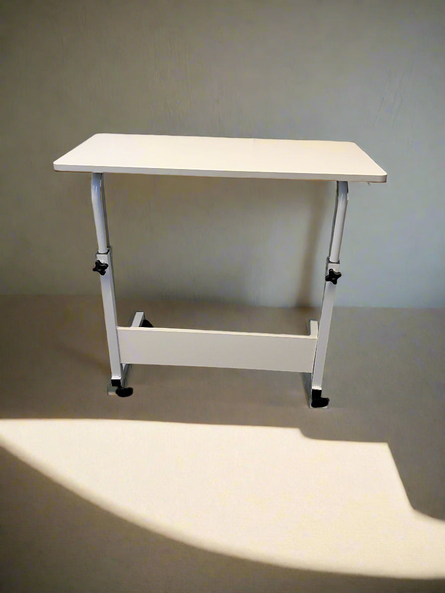 White adjustable desk against a plain wall