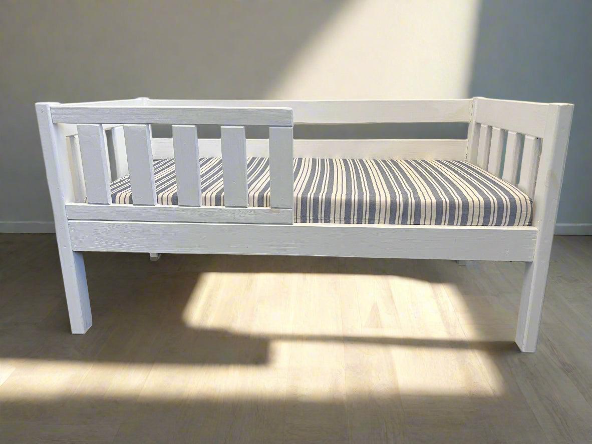 Compact White Wooden Daybed with Striped Mattress