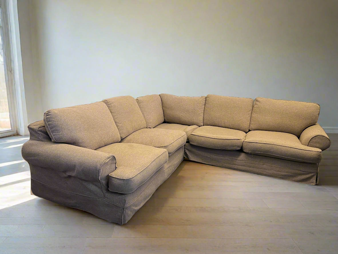 Beige sectional sofa in a room with a neutral color scheme