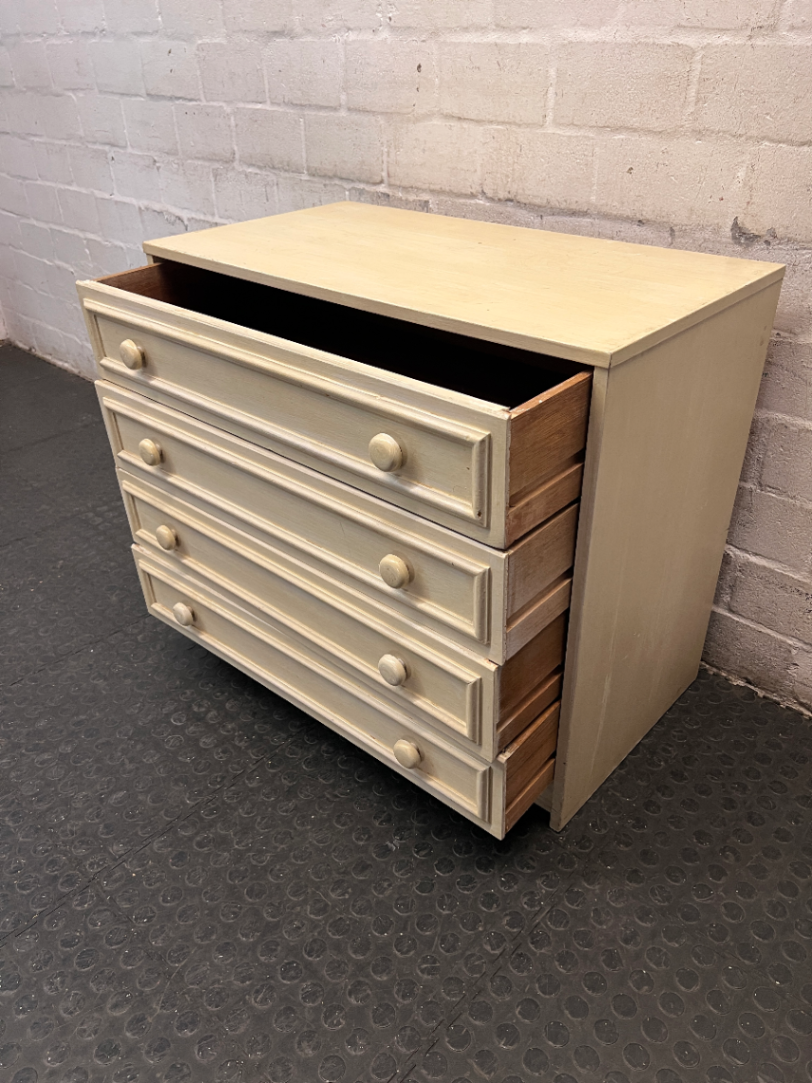 Cream Four-Drawer Chest with Moulded Panelling — Fair Condition with Visible Wear