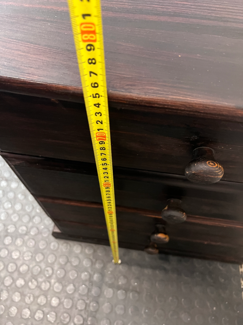 Dark Stained Wooden 4-Drawer Chest — Visible Wear and Surface Marks