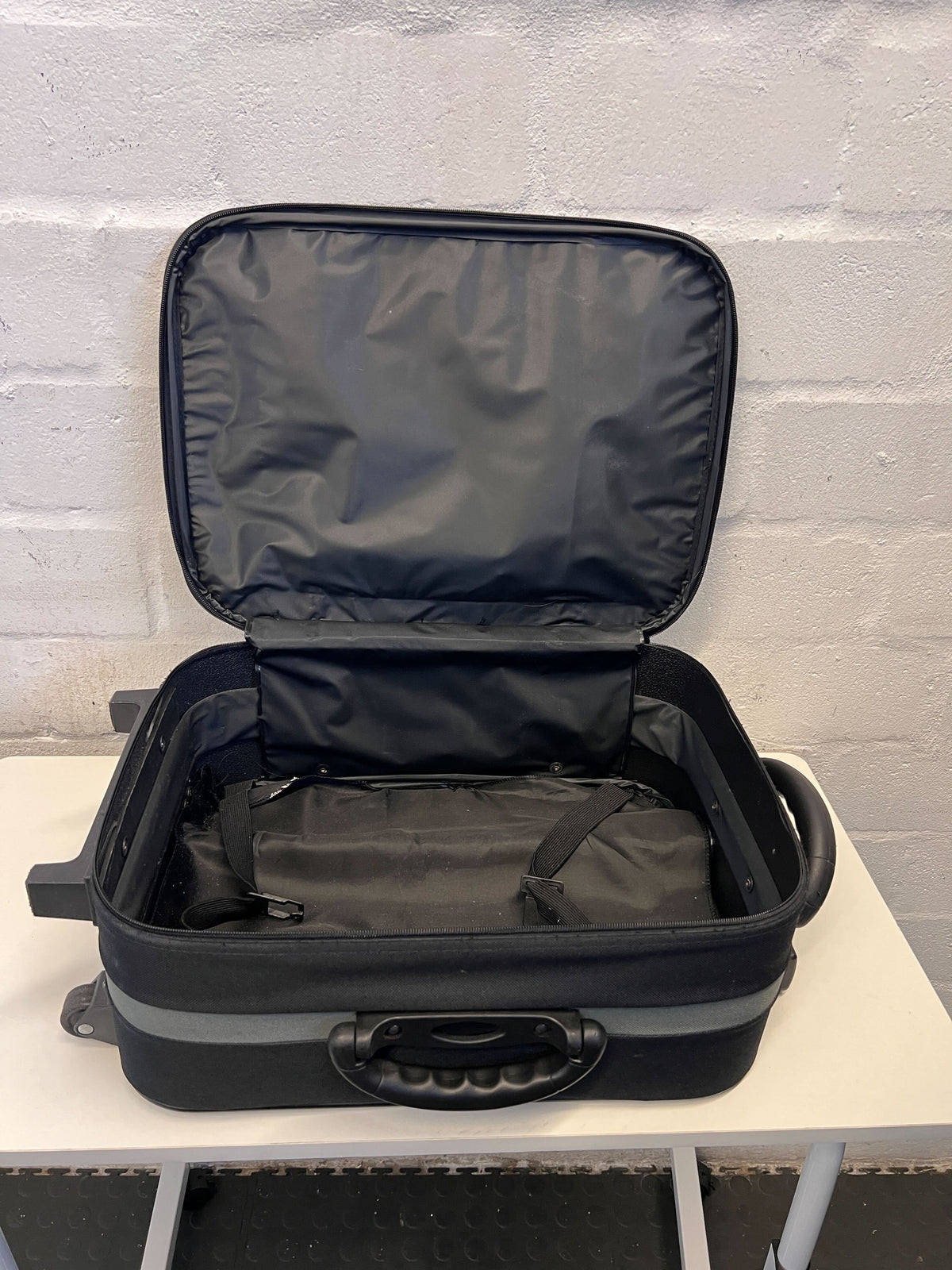 Elegant Black Rolling Travel Suitcase with Minor Wear