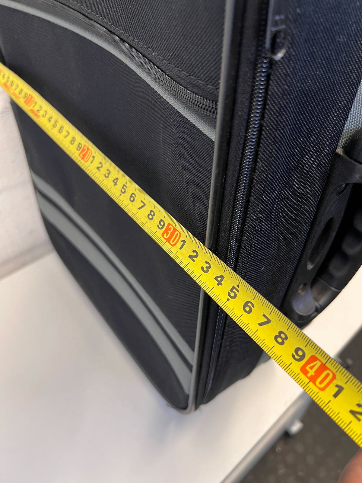 Elegant Black Rolling Travel Suitcase with Minor Wear