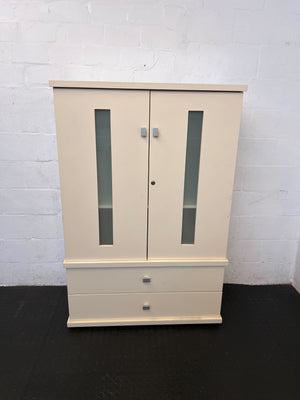 Beige wardrobe with glass panels against a white brick wall.