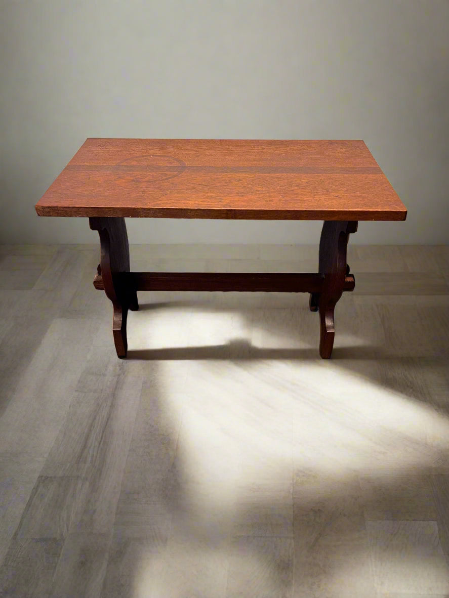 Wooden table against a gray brick wall