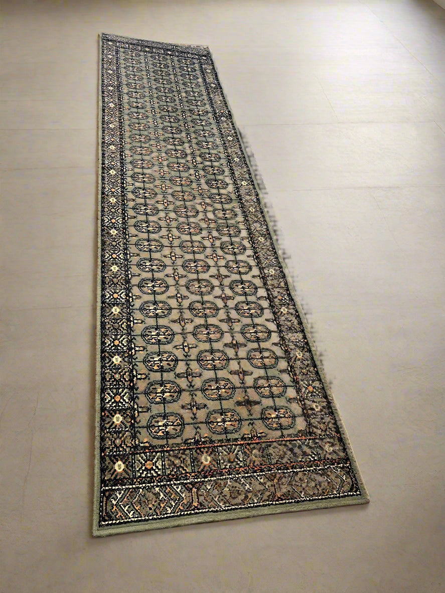 Long rectangular rug with a geometric pattern on a plain background