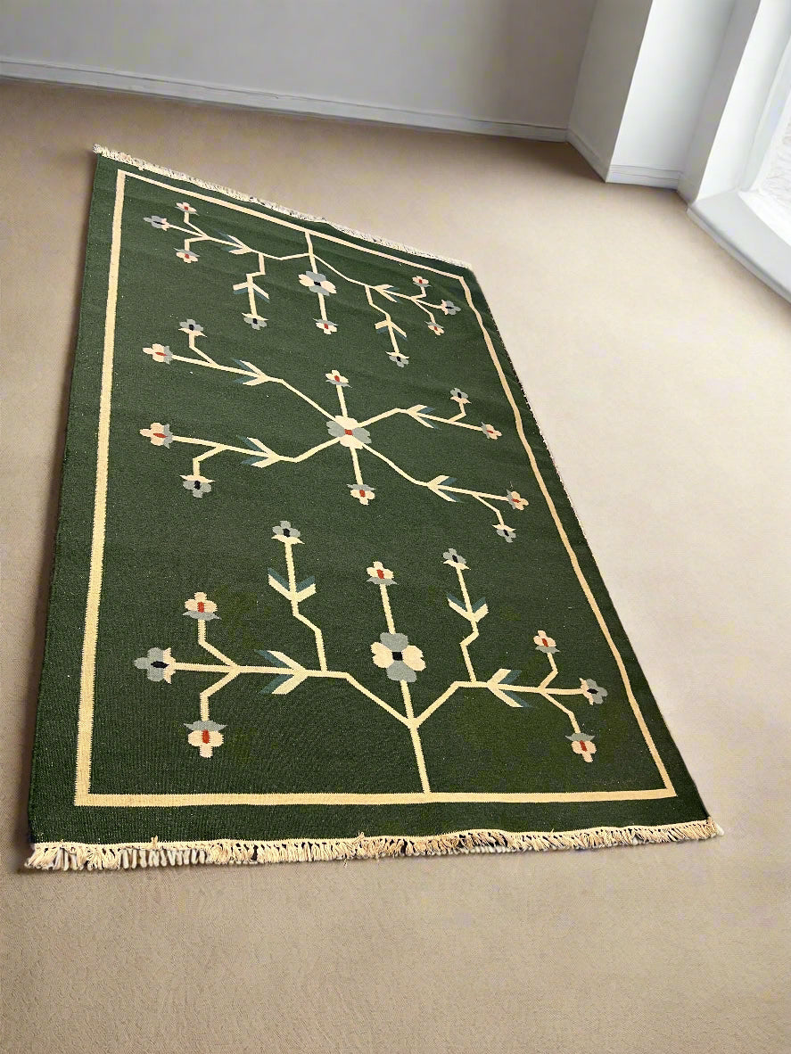 Green rug with floral pattern on a beige floor