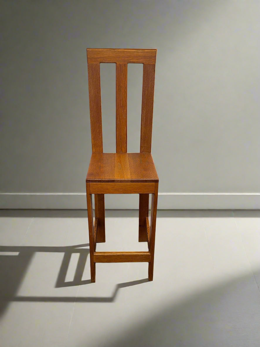 Wooden chair against a plain wall with a light gray floor.