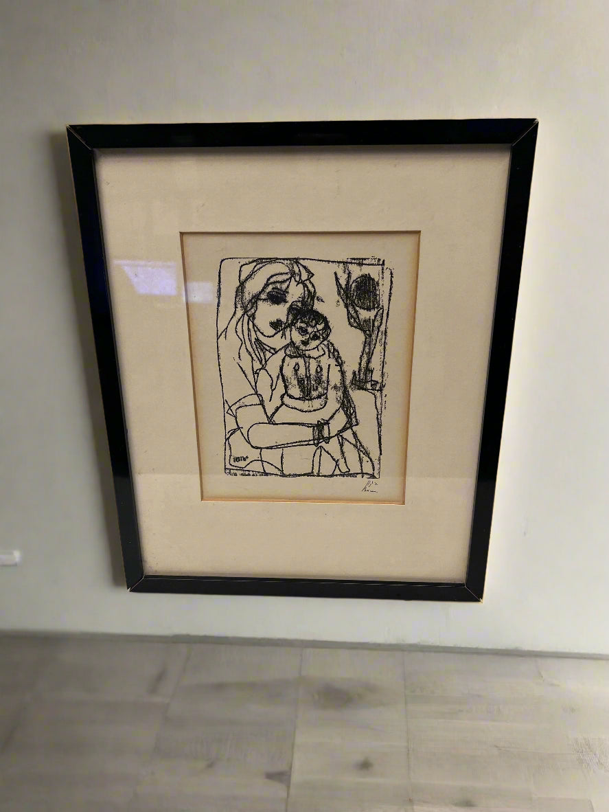 Framed black and white artwork on a plain wall