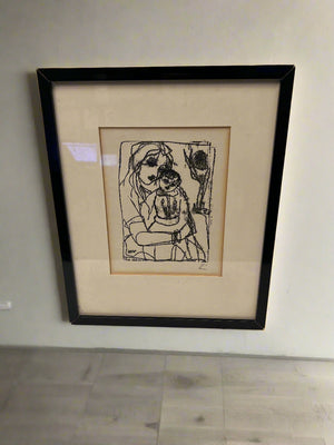 Framed black and white artwork on a plain wall
