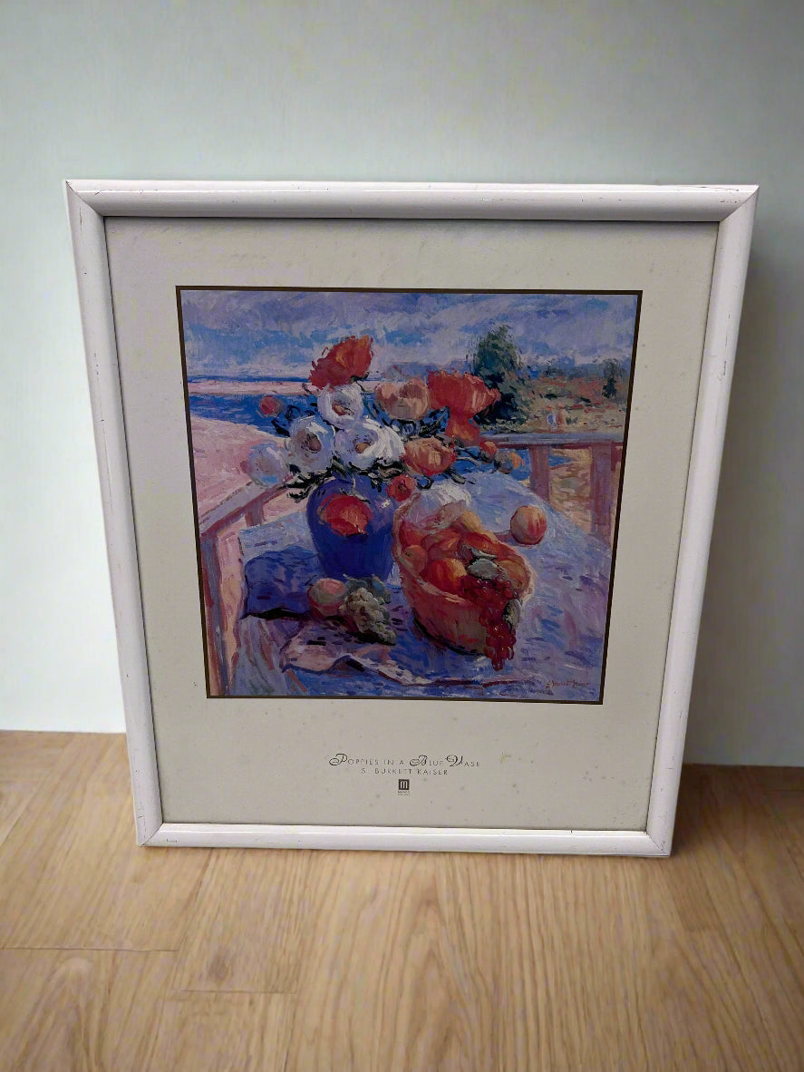 Framed artwork of a still life scene with flowers and fruits on a table.