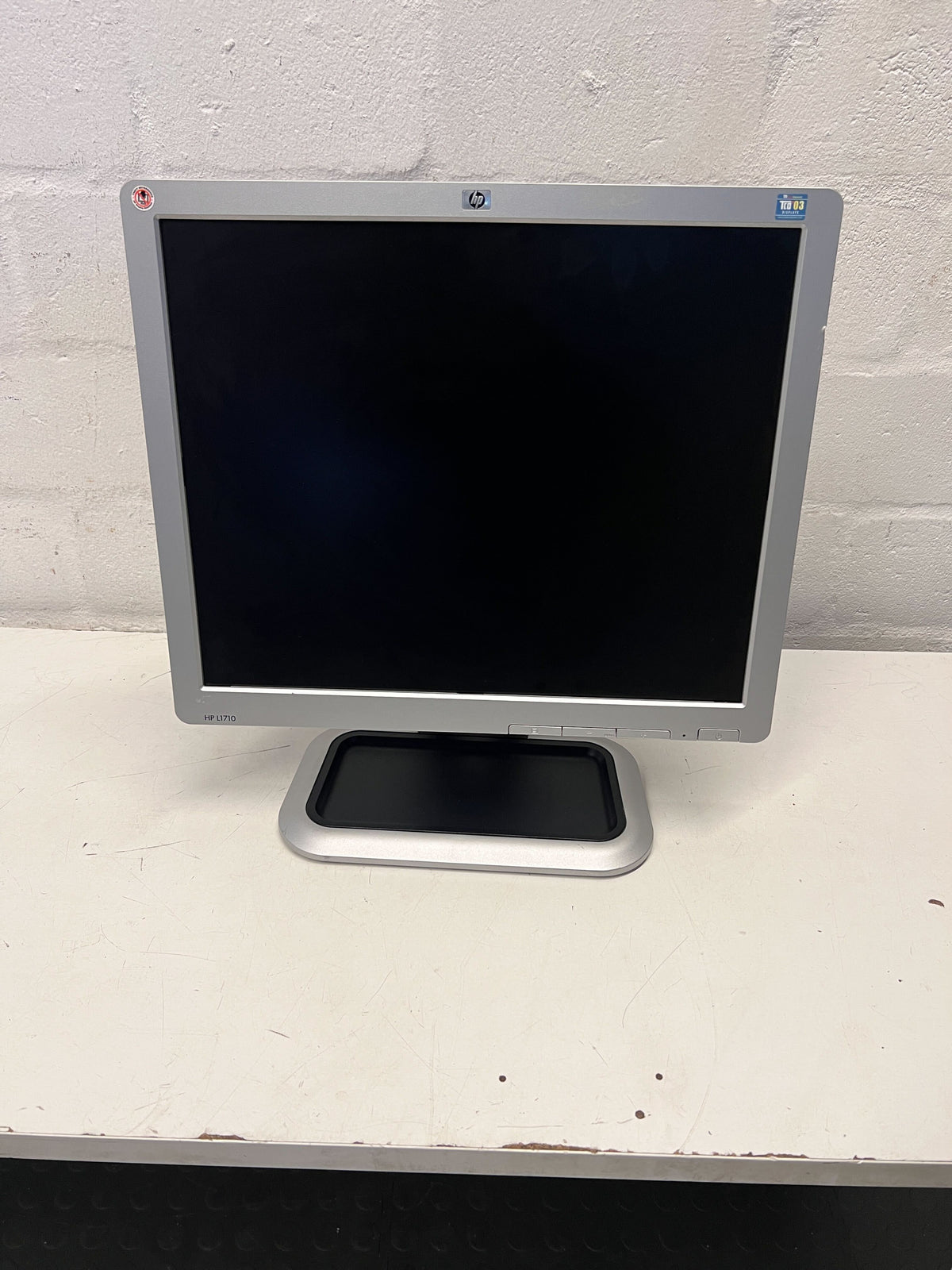 HP computer monitor on a white surface with a light gray background