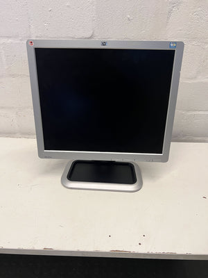 HP computer monitor on a white surface with a light gray background