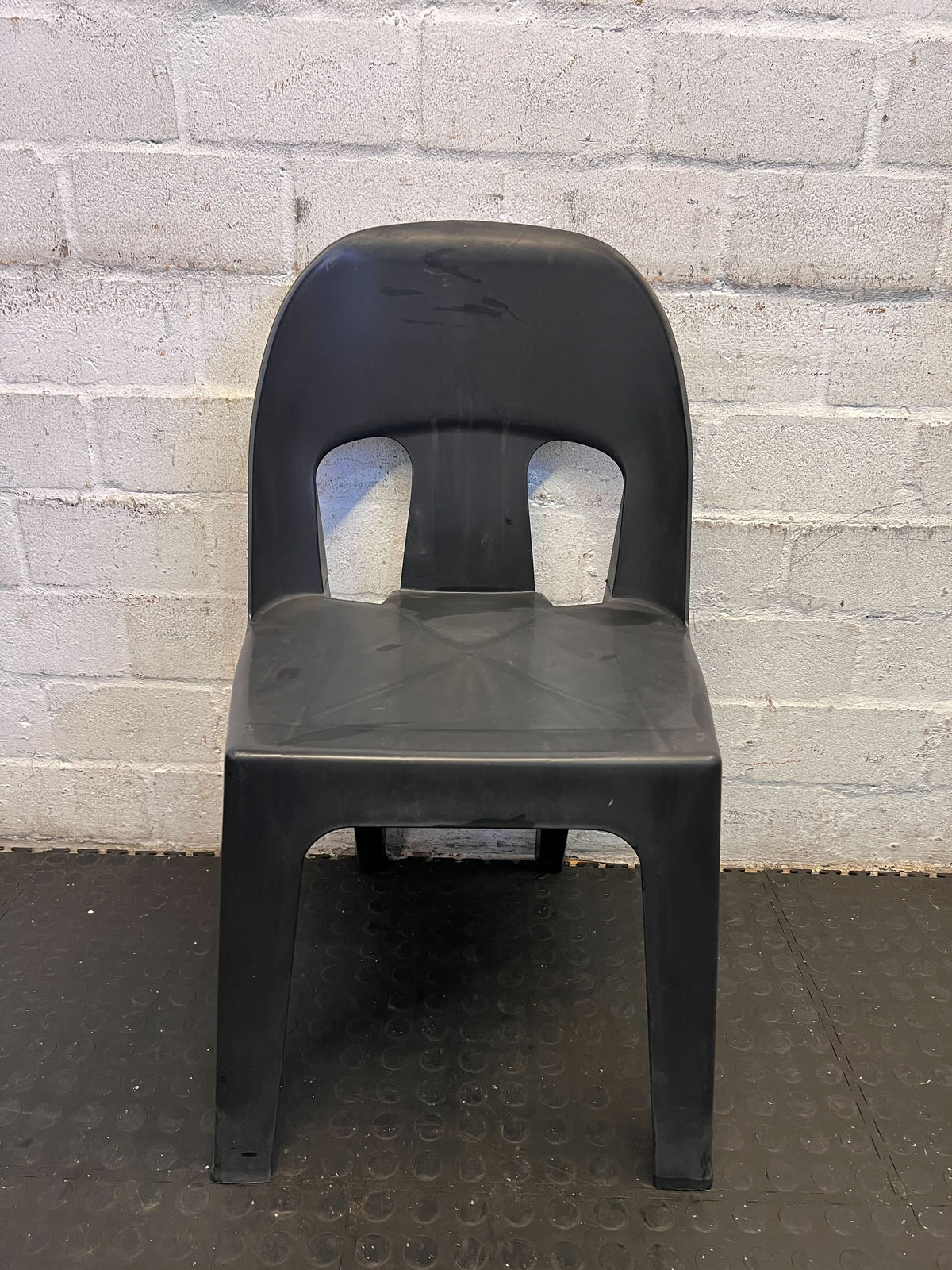 Sturdy Black Plastic Stackable Chair - Minor Wear, Great for Outdoor Use