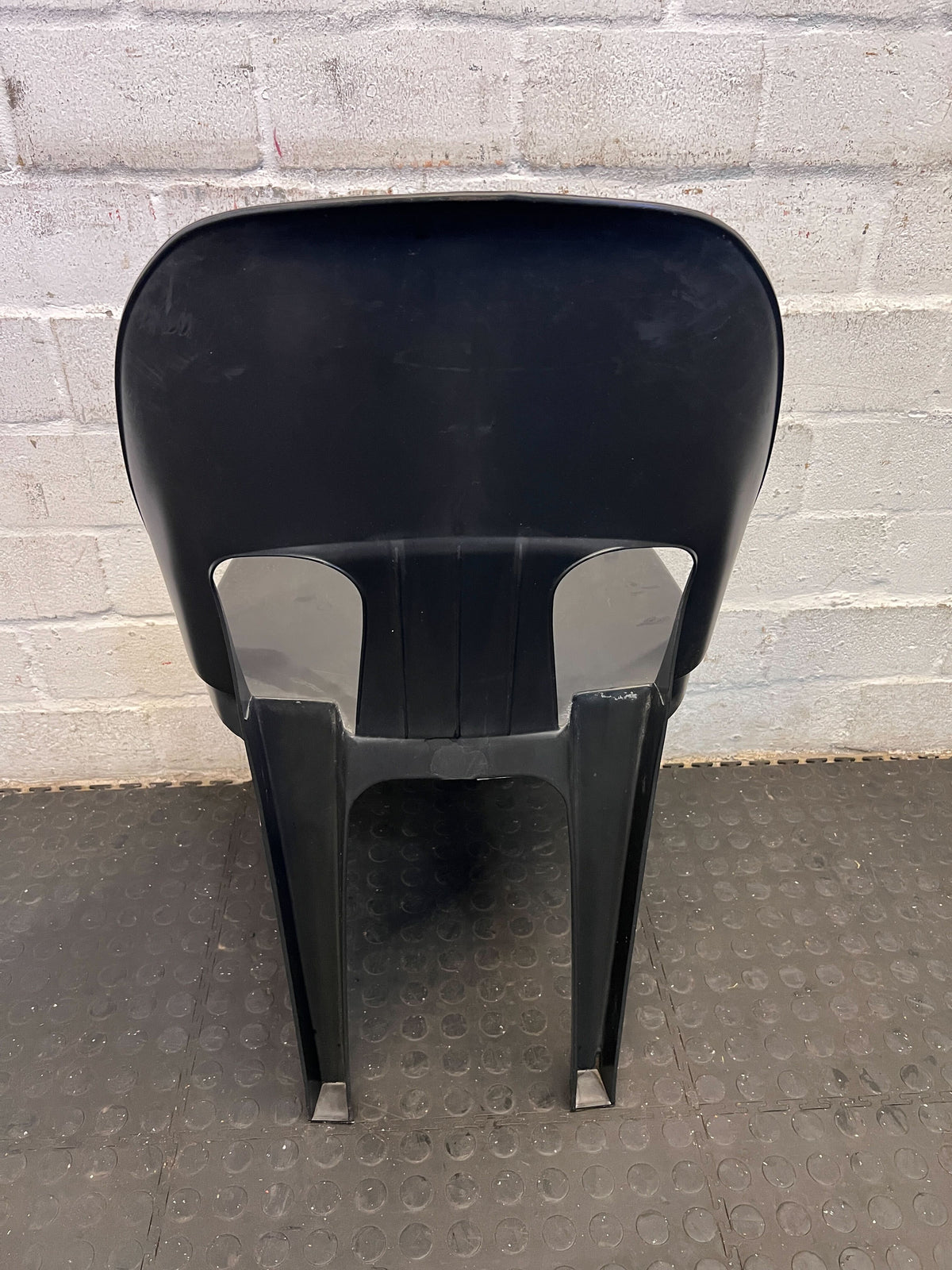 Sturdy Black Plastic Stackable Chair - Minor Wear, Great for Outdoor Use