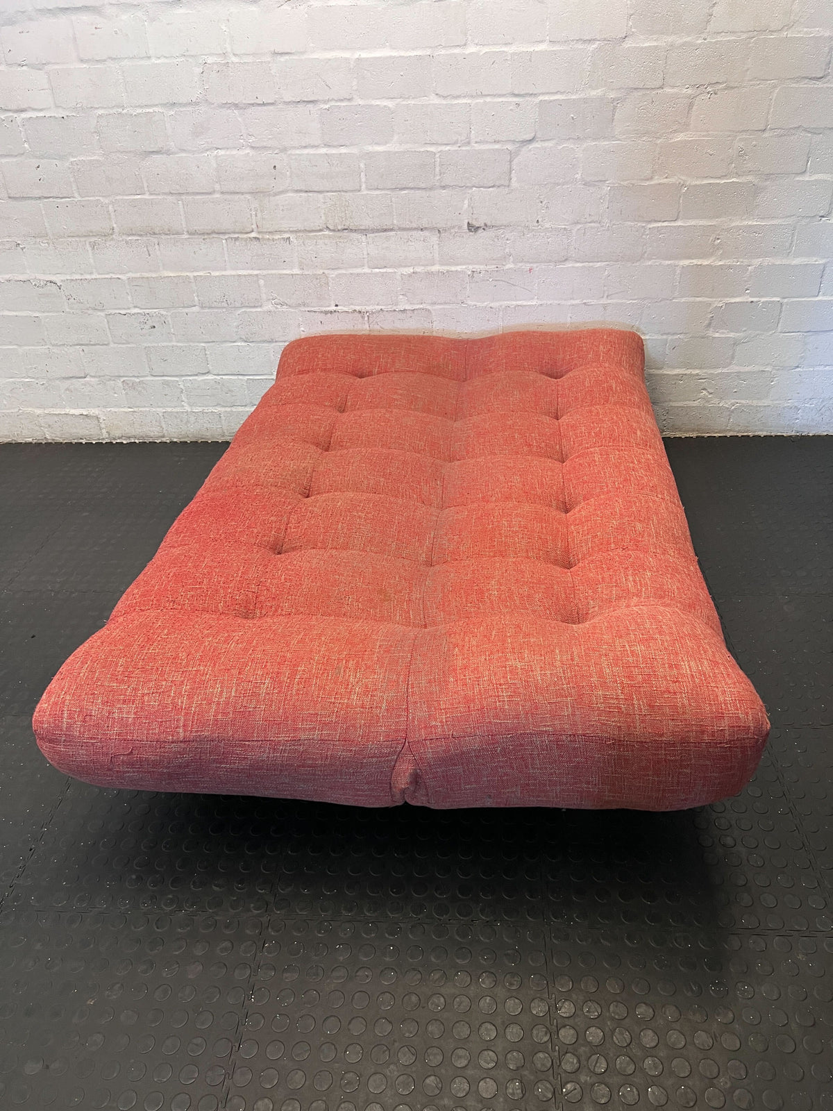 Compact Coral Tufted Sofa / sleeper couch slight tear on materiel at the bottom - 2ndhandwarehouse.com
