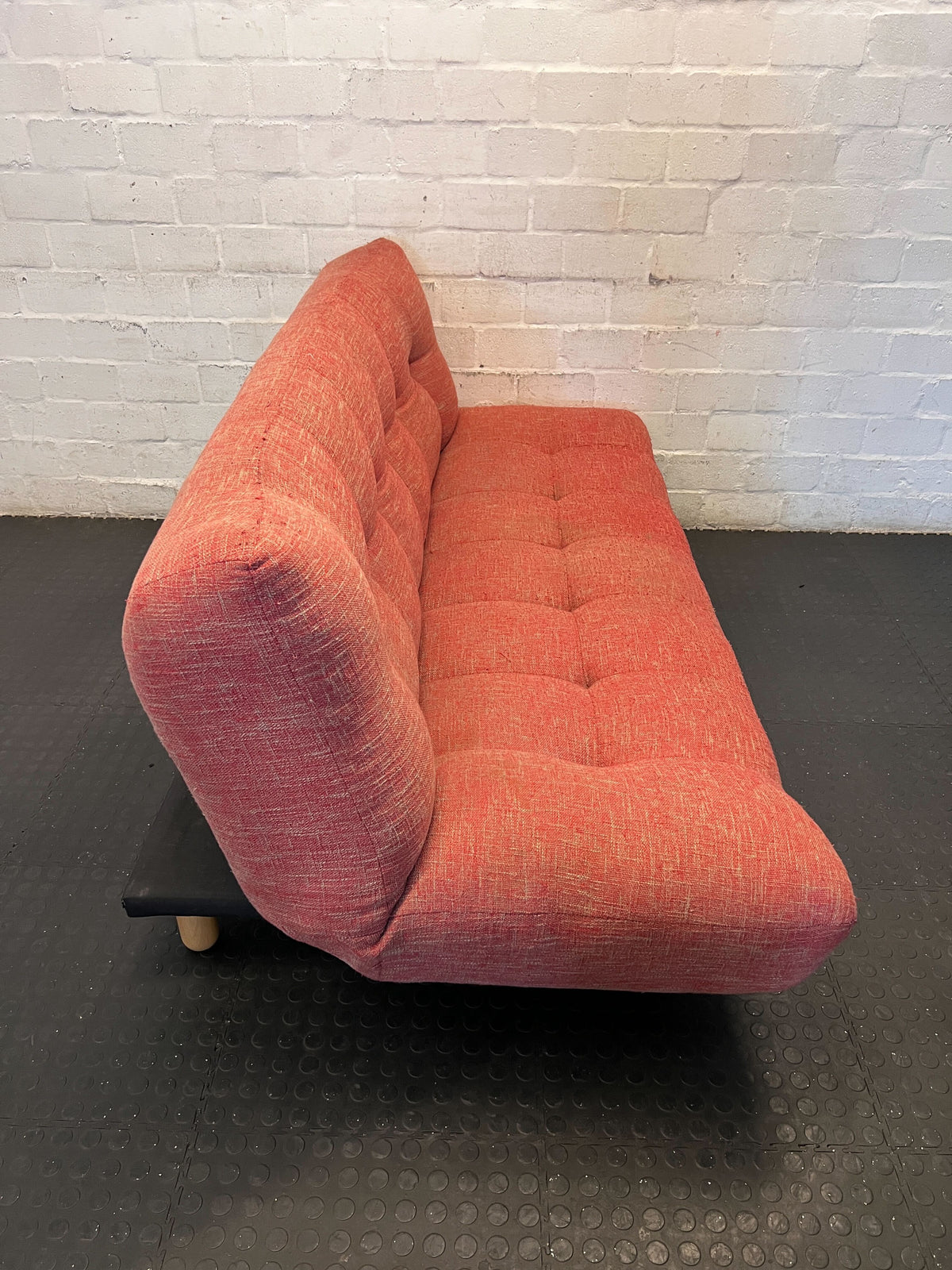 Compact Coral Tufted Sofa / sleeper couch slight tear on materiel at the bottom - 2ndhandwarehouse.com