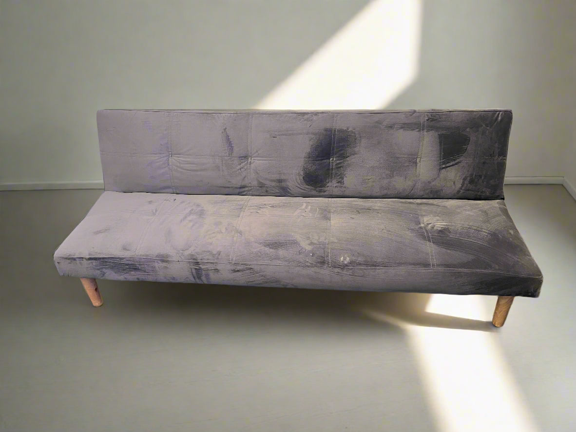 Gray upholstered bench against a plain wall