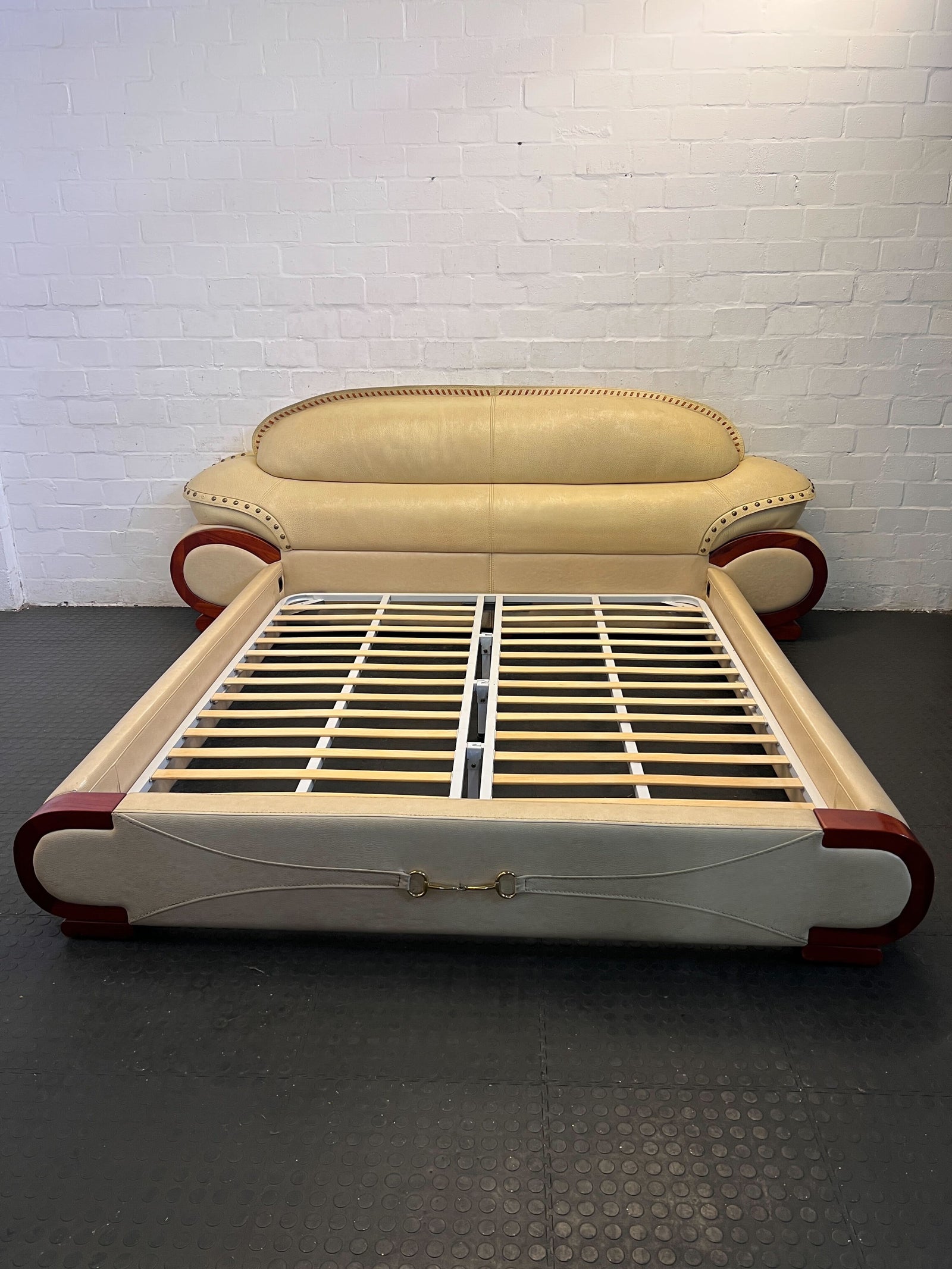 Elegant Cream King sized Leather Sofa Bed with Stylish Red Accents