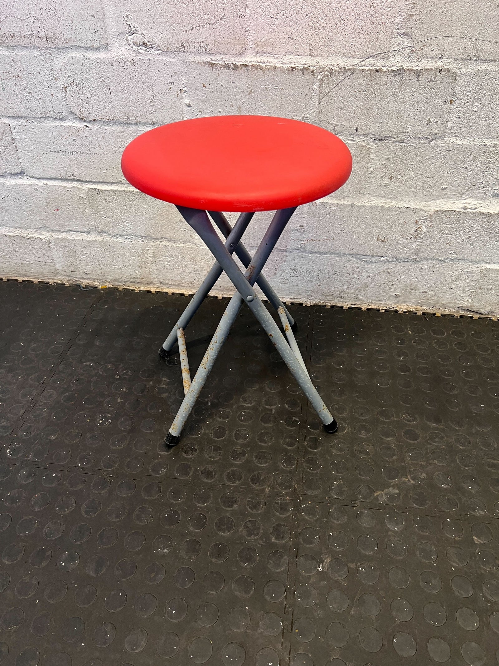 Compact Red Folding Stool with Metal Frame – Good Condition