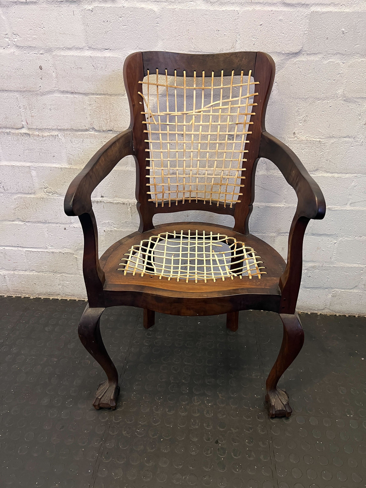 Elegant Vintage Dark Wood Armchair with Woven Seat